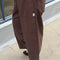 side view of model wearing brown gardners pants with front patches