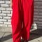 model wearing red draped relaxed fit pants