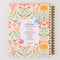 back view of cream large 17-month planner with colorful abstract floral and pink elastic closure