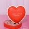red heart shaped jewelry box with pink interior and cream scalloped detail with 'sweet little jewelry' across the front with jewelry inside