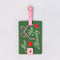 green luggage tag with pink strap and trim with 'miss you already' in cursive
