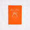red notebook with white 'love notes' typography and white bow