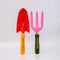 set of two metal gardening tools: red and yellow 'plant parent' towel and pink and green 'plant parent' trident