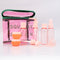 up close of pink and green plastic 'squeaky clean' travel kit with two pots, a funnel, mini spatula, one pump, one spray bottle and label sheet with the contents outside of the pouch