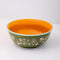 Small ceramic serving bowl with vintage-inspired floral and strawberry design, colorful finish, and blue rim