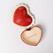 inside of ceramic heart shaped trinket box with white scalloped trim and cursive 'everything' in the inside