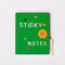 green sticky note folio with white 'sticky notes' on the front with colorful shaped and gold string closure