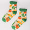 Pair of cozy socks with colorful veggie pattern and grip bottoms, shown on a light background.