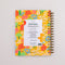 back view of yellow large 12-month planner with green elastic closure and colorful floral print