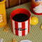 red and white vertical stripe mug with yellow ball handle and double sided typography with 'BONJOUR!' on one side and 'AU REVOIR' on the other