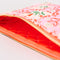 red interior of pink folk floral quilted pouch