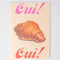 cream notebook with colorful 'oui! oui! and croissant