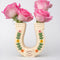 cream horseshoe ceramic vase with colorful flower trim and 'best of luck' stamp in the center with pink roses inside