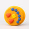 Side view of smiling pancake de stress ball with cute face design
