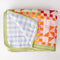 folded colorful patchwork print quilted blanket with light green trim