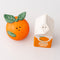 top view of orange shaped and orange juice carton salt and pepper shakers