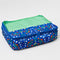 blue packing cube with colorful folk floral and green pocket