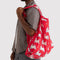 model carrying red big baggu with all over bunnies print