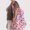 model carrying multicolor big baggu with all over cherry print