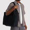 model carrying black cloud carry-on