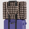 brown blurred gingham cloud carry-on on a suitcase