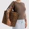 model carrying brown leopard cloud carry-on