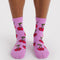 model wearing pink socks with all over cherry print