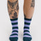 model wearing malachite and blue striped crew socks