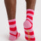 back view of pink and red stripe crew socks