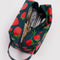 green dopp kit with all over strawberry print with items inside