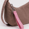pink logo keychain with smiley face print on a brown bag