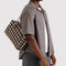 model carrying brown blurred gingham medium bowler bag