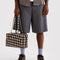 model holding brown blurred gingham medium bowler bag