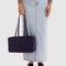 model holding fig (dark purple) medium nylon bowler bag