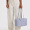 model holding mist gray medium bowler bag