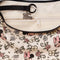 black interior key leash of cream medium crescent bag with mickey and minnie head print with dainty flowers