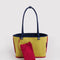 reversed side of reversible navy tote with yellow interior and red trim