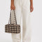model holding brown blurred gingham nylon bowler bag