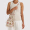 model wearing cream drawstring bag with abstract floral print