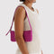 model carrying deep fuchsia pochette
