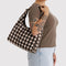 model carrying brown blurred gingham nylon shoulder bag