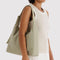 model carrying celadon (sage) nylon shoulder bag
