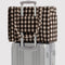 blurred gingham brown small cloud carry on bag on a suitcase