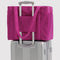 deep fuchsia small cloud carry on bag on a suitcase