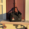 black small cloud carry on bag with minnie mouse face and signature on a ledge