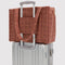 tan houndstooth small cloud carry-on bag on a suitcase