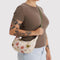 model carrying abstract floral small crescent bag