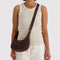 model carrying coffee small crescent bag