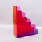 back view of red, pink, yellow and blue acrylic wavy file folder holder