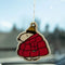 snoopy in a large red puffer air freshener hanging from a mirror